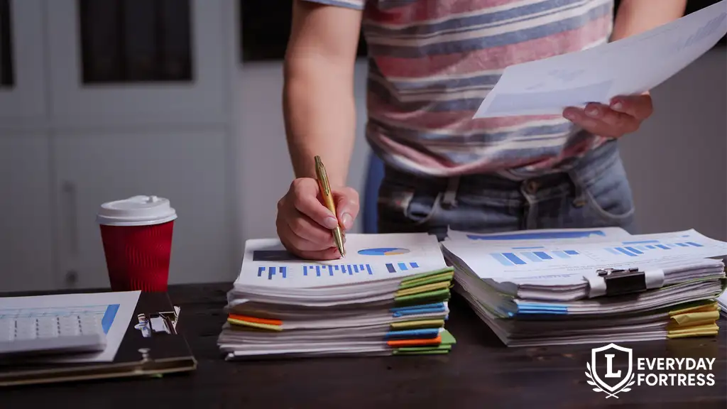 Man working at home desk organizing legal and personal documents