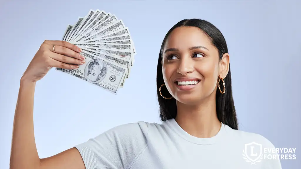 Young woman holding up banknotes, representing personal lending and interest income